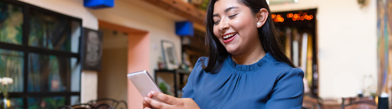 Woman talking on cell phone in home office