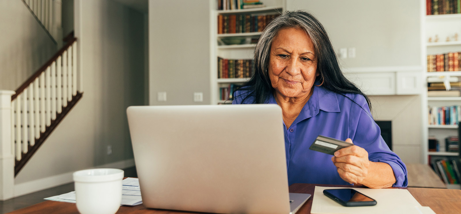 Woman using credit card and laptop
