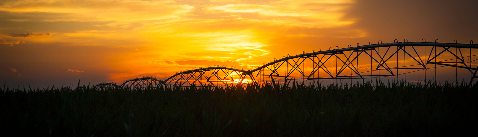 Farm equipment at sunrise